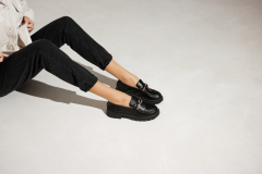 black loafers on female legs close-up